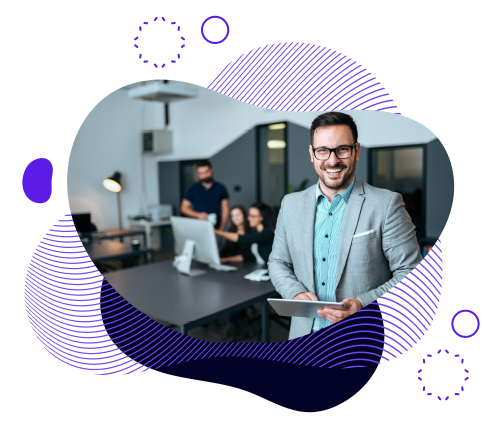 A man in a suit smiles while holding a tablet, with others in the background-The Buzz marketing